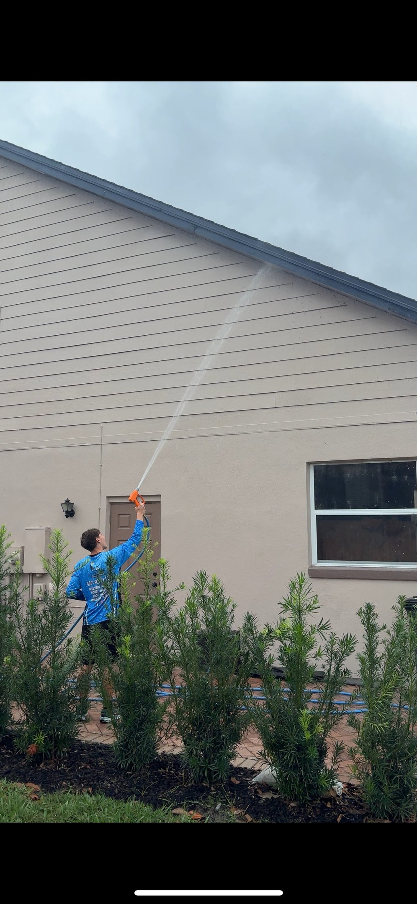 SplashKingz soft washing a roof and home exterior